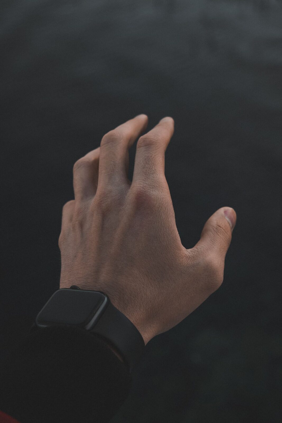 Close-up of a smartwatch on a wrist in low light, illustrating overnight sleep tracking
