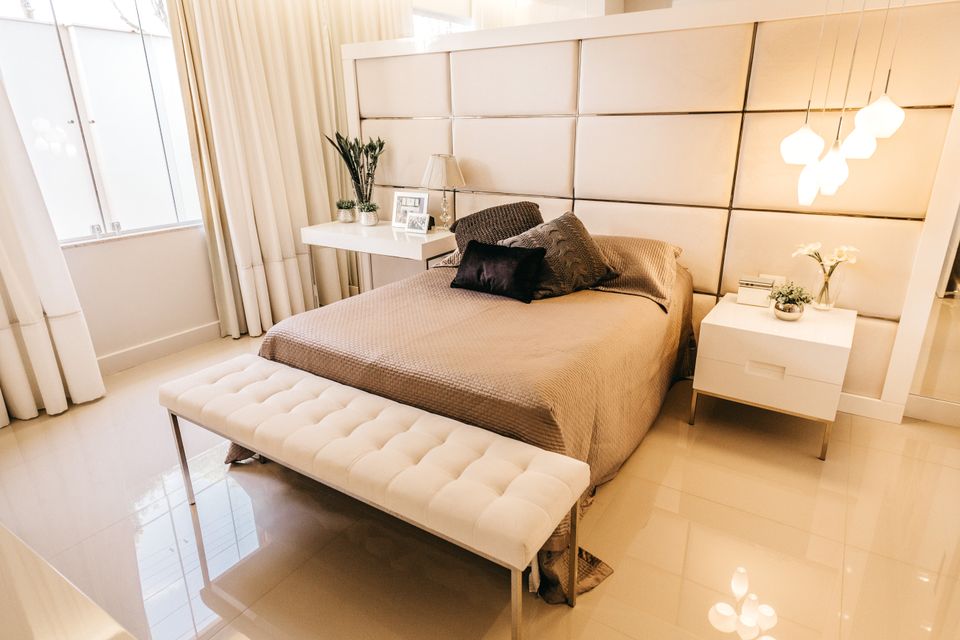 Small, cozy modern bedroom with a bed and soft ambient lighting, the kind of tight space a dorm or apartment projector needs to fill