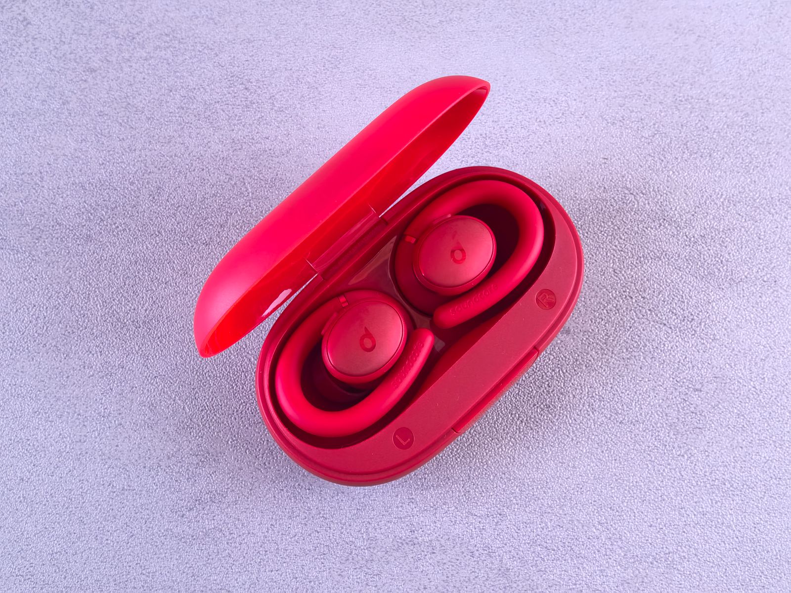 Pair of wireless earbuds resting open in their charging case