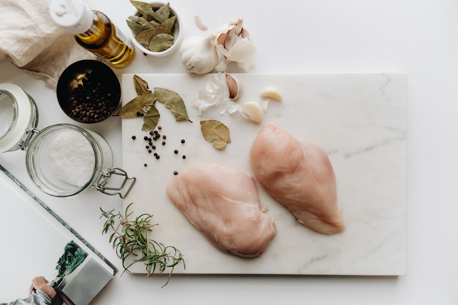 Raw whole chicken sitting on a cutting board before being broken down