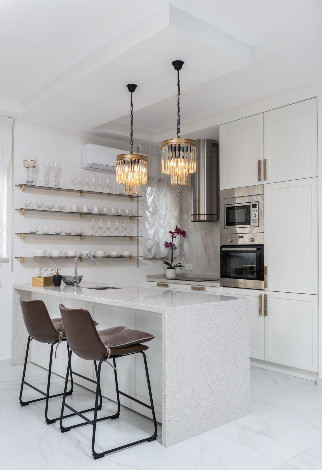 Bright modern kitchen counter and white cabinets where under-cabinet lighting would sit