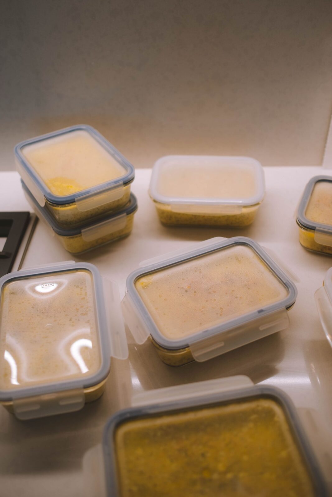 Several lunch boxes filled with portioned, batch-cooked meals arranged on a table