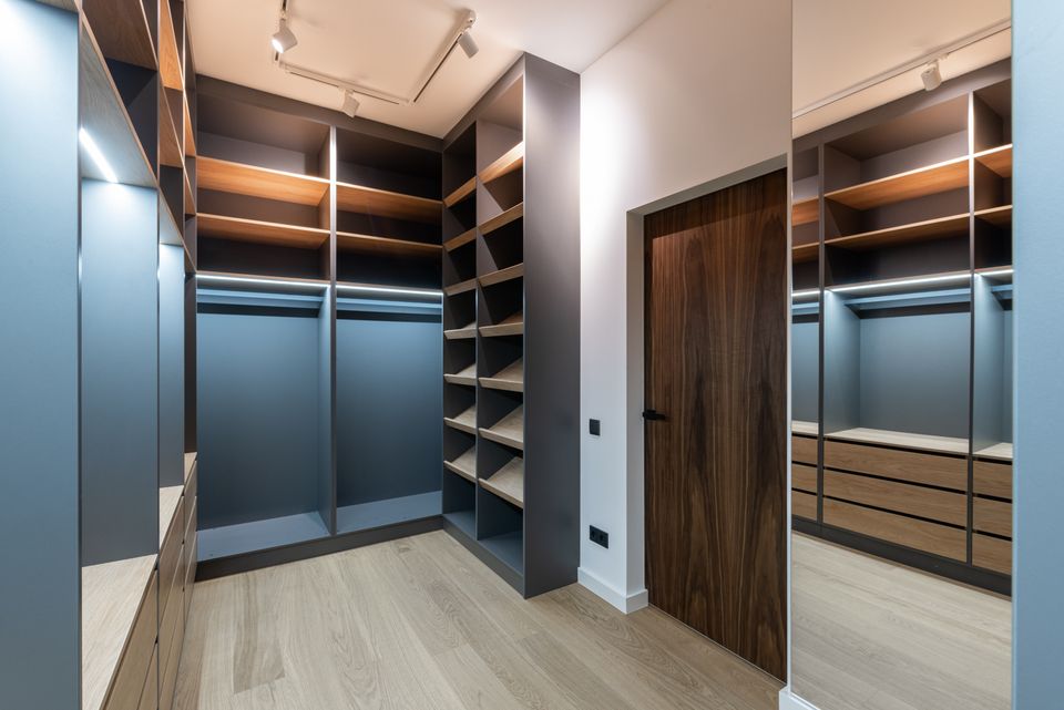 Walk-in closet with open wooden shelf compartments, the kind of space cube organizers are built to fit into