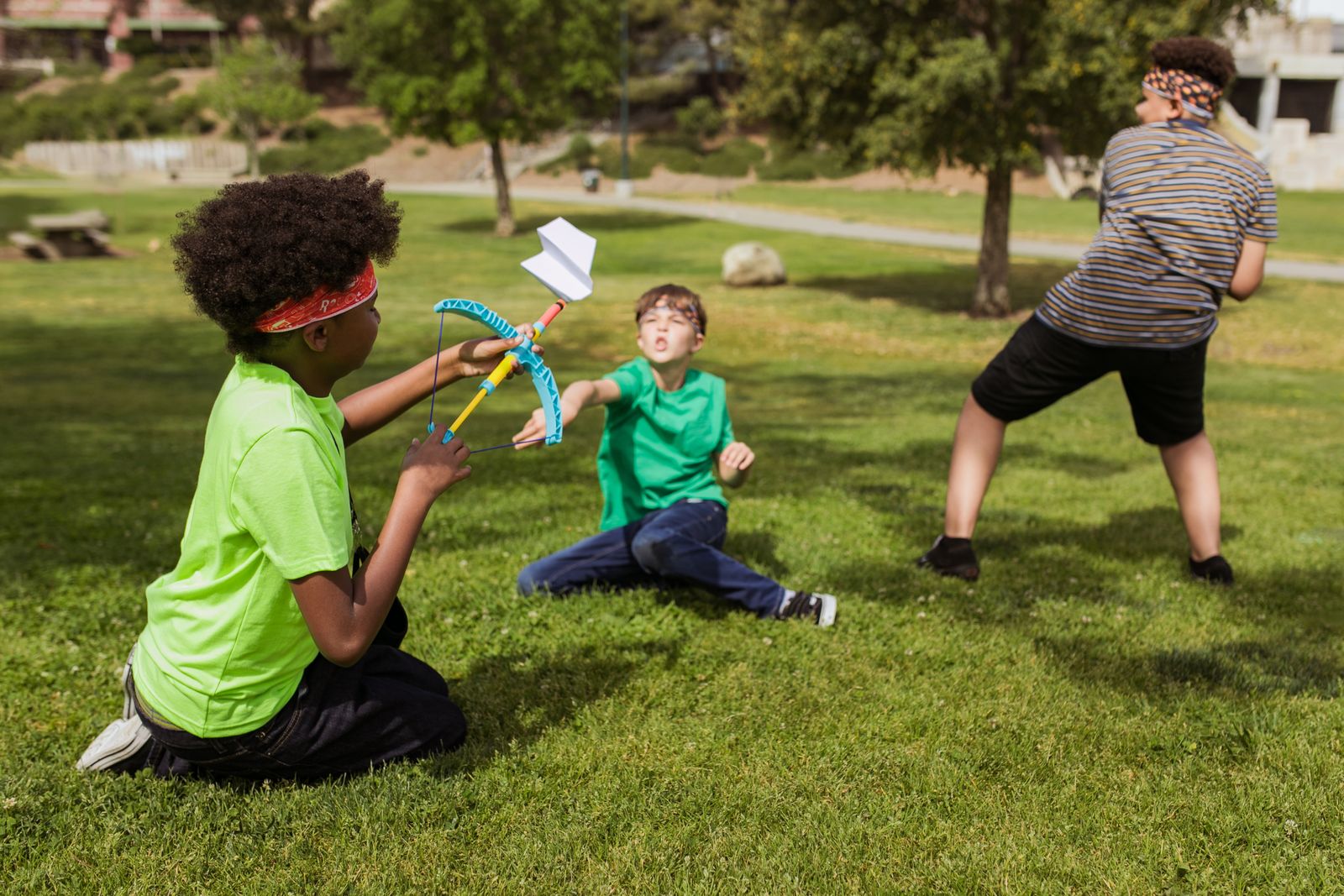 Kids playing outside together at a park on a sunny day