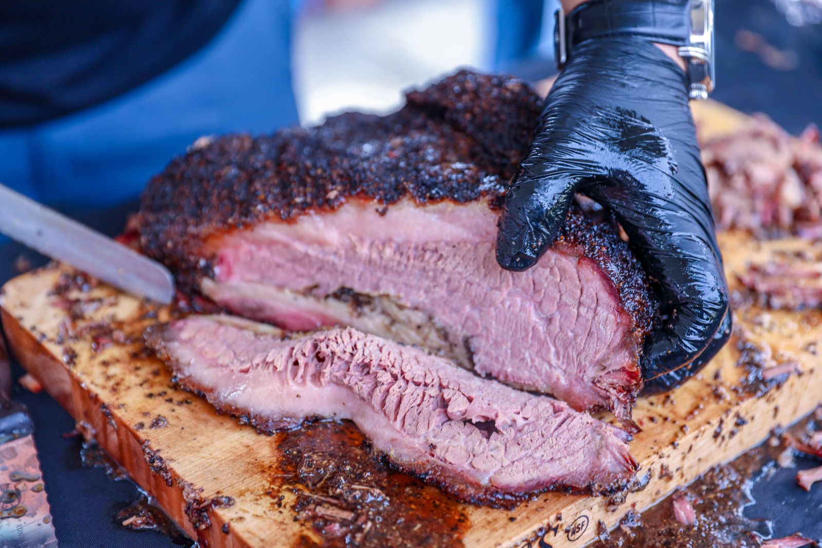 Sliced smoked brisket resting on a wooden cutting board