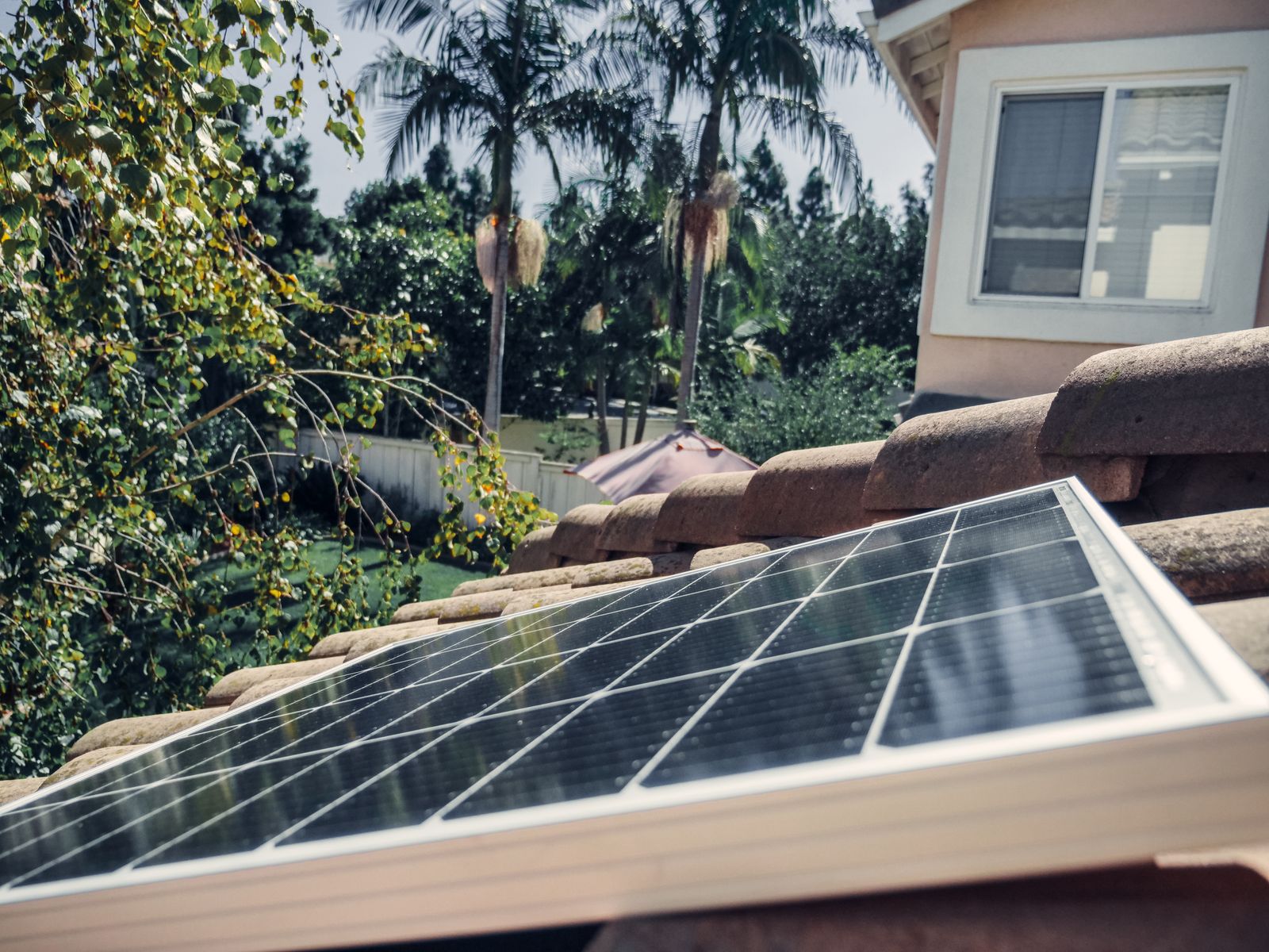 Close-up of a solar panel mounted on a residential tile roof, the kind of panel used to recharge a solar-expandable power station