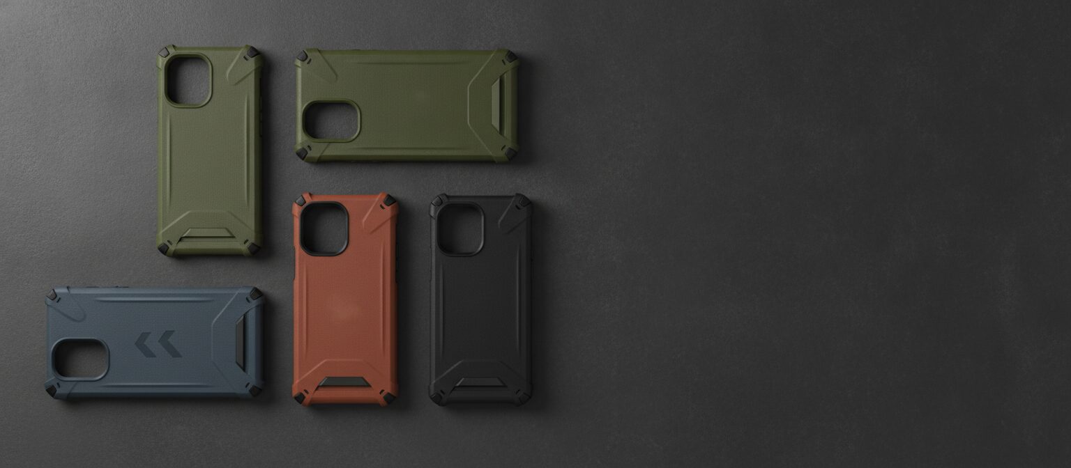 Four unbranded rugged phone cases in different colors arranged flat on a concrete surface