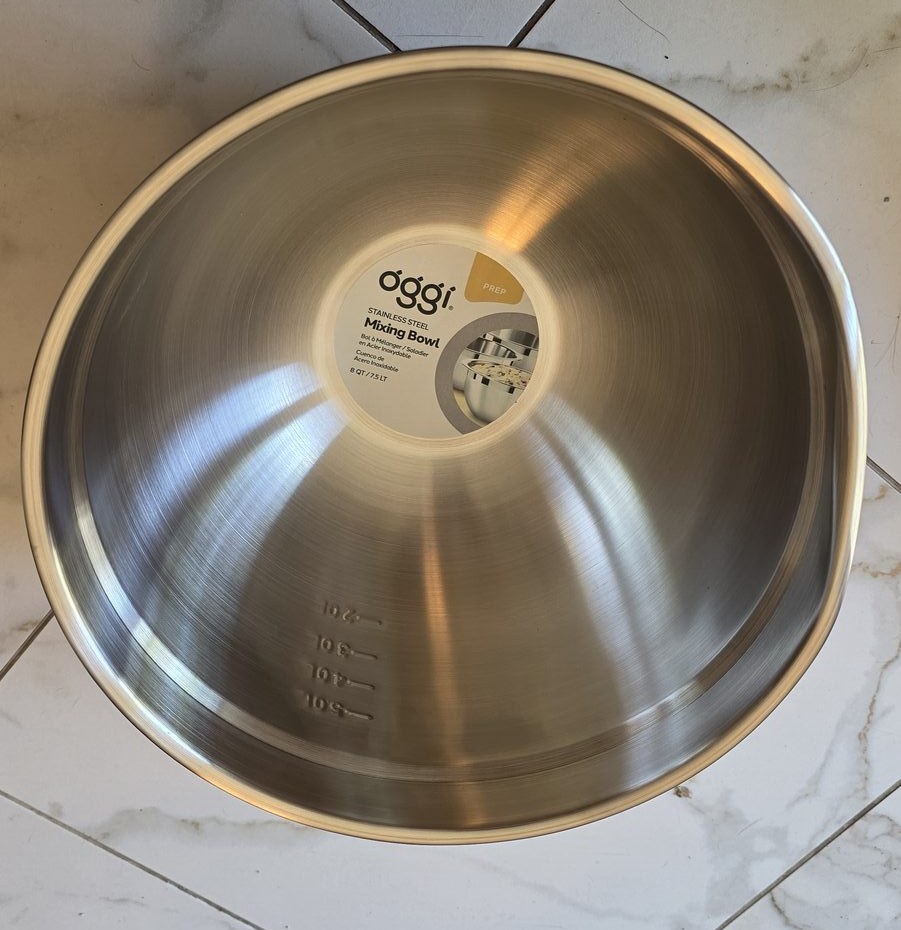 Inside of an Oggi 8 quart stainless mixing bowl with embossed quart markings and product label